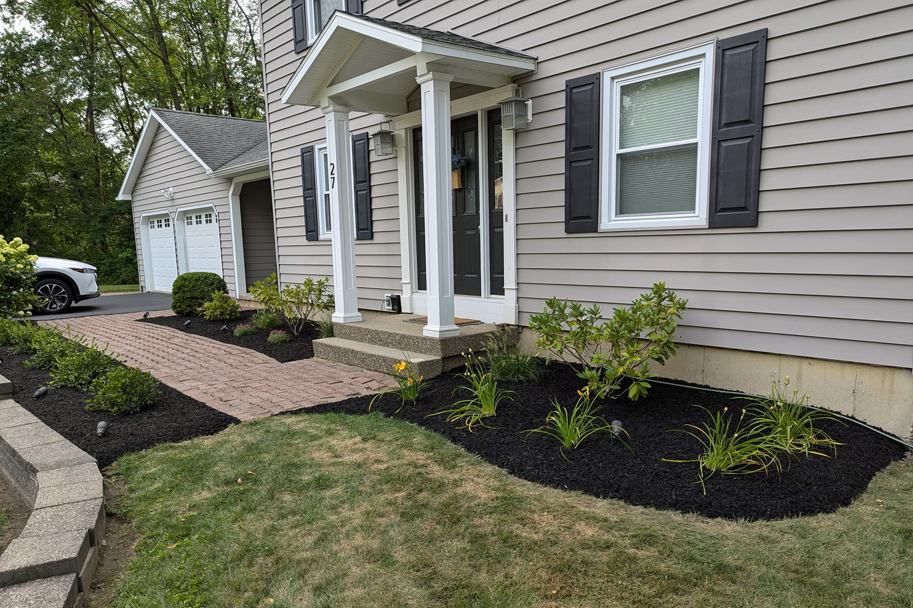 Thumbnail of installation of stone sidewalk in front of house