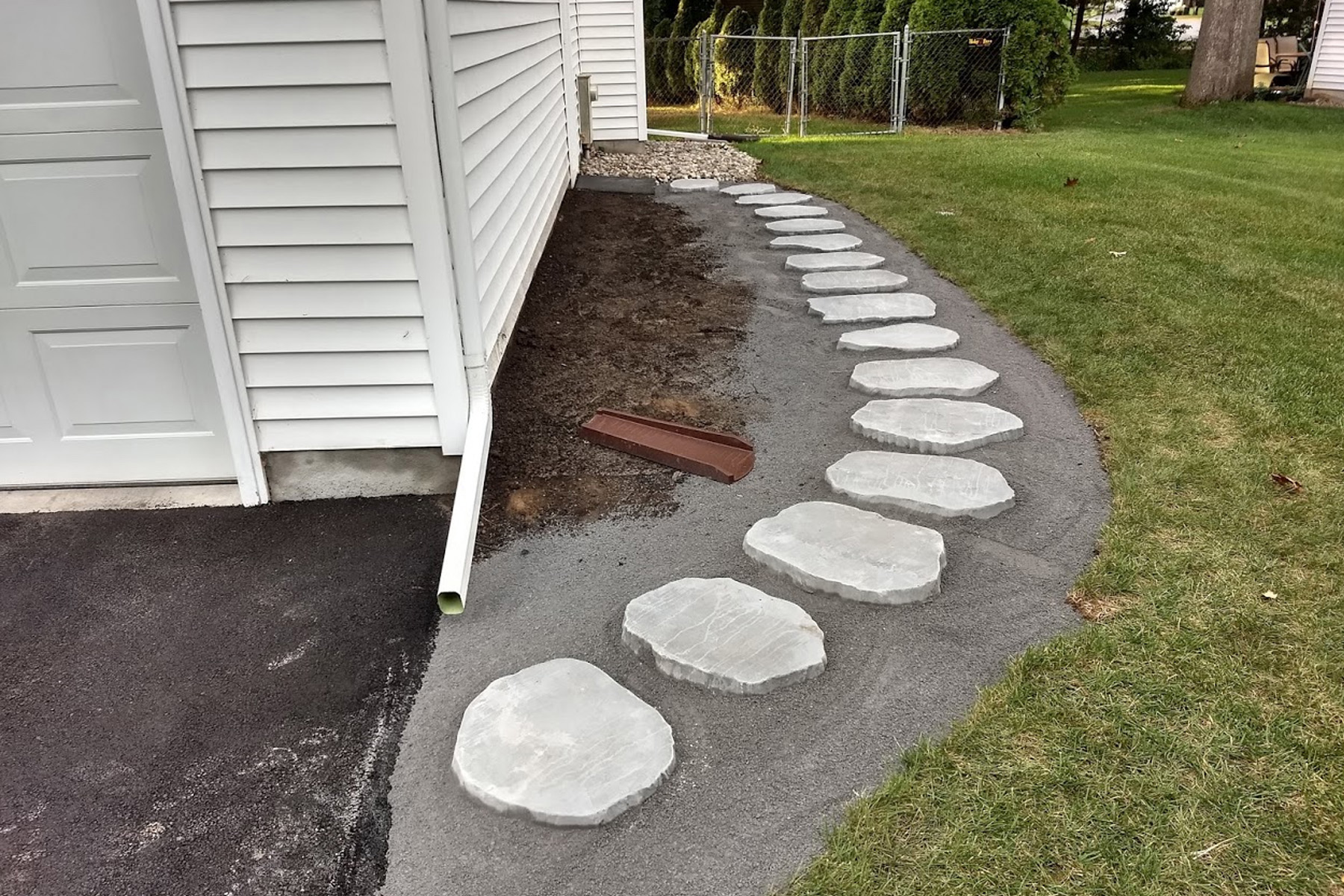 Thumbnail of the pavers set in sand along the side of the garage